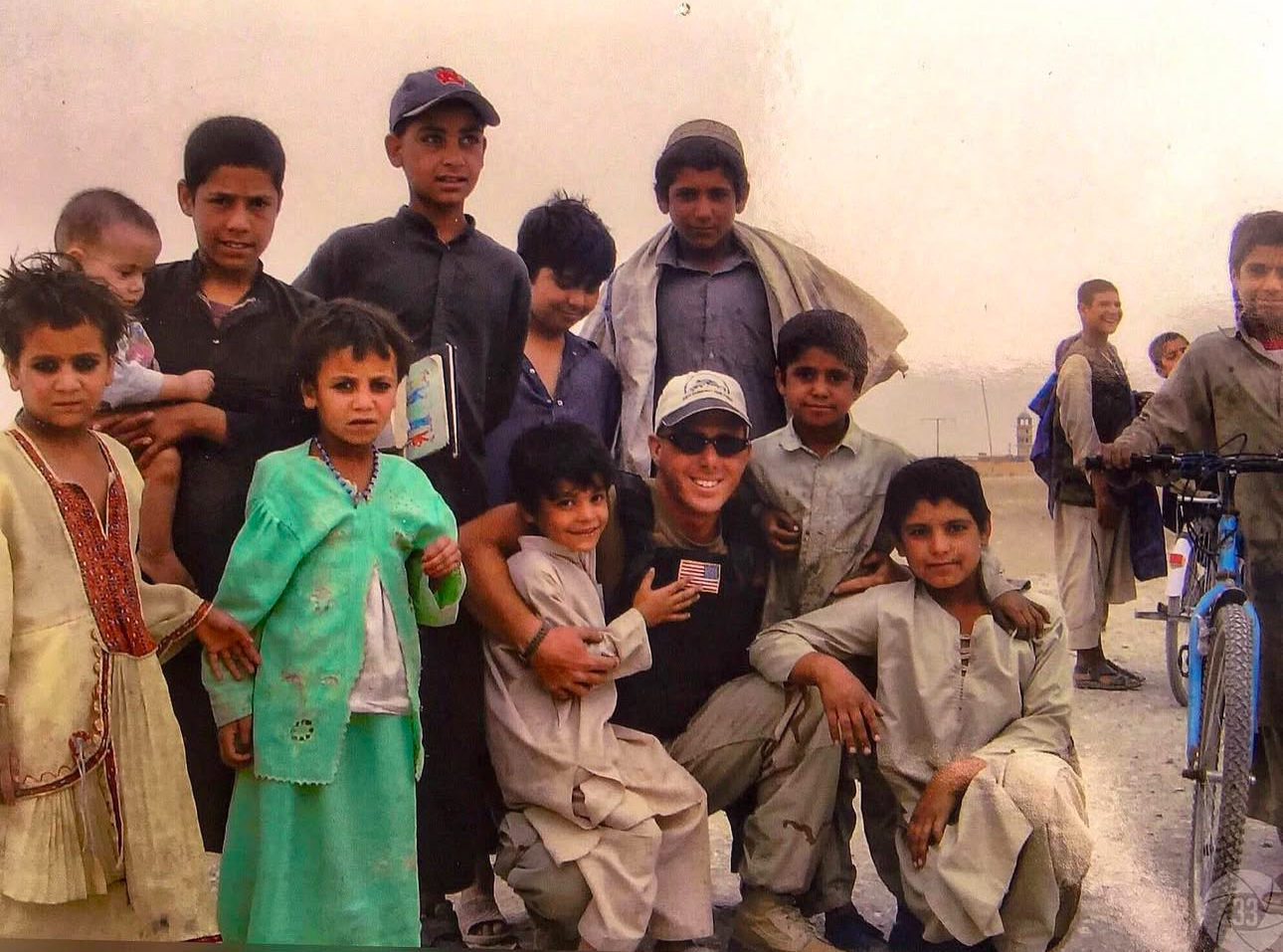 Jay Kaps on deployment with local children